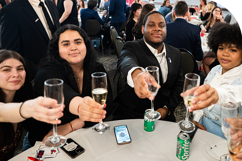 students toasting with champagne at senior toast
